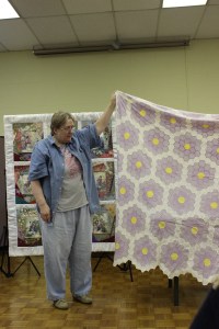 Avis Withers with antique hexagon quilt